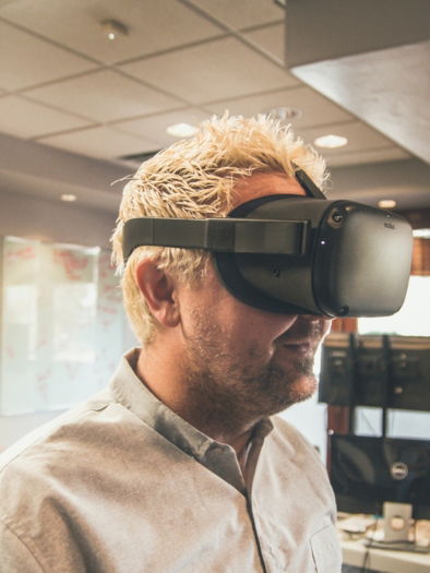 man standing and using virtual reality headset